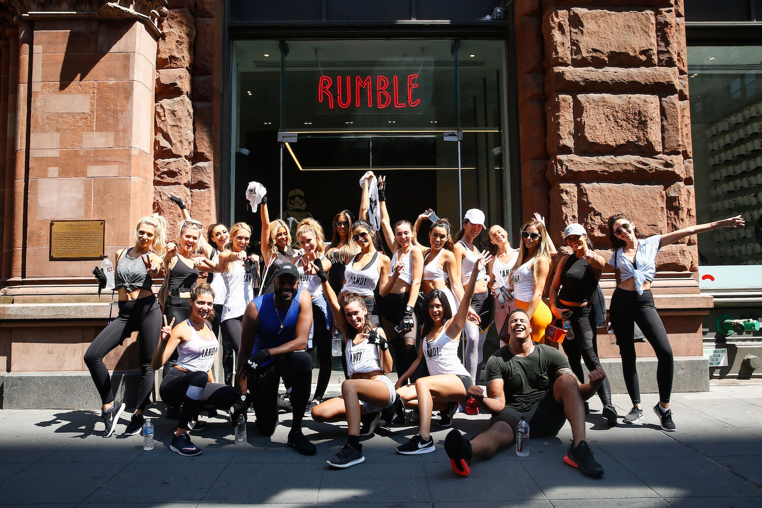 Group posing in front of a Rumble building
