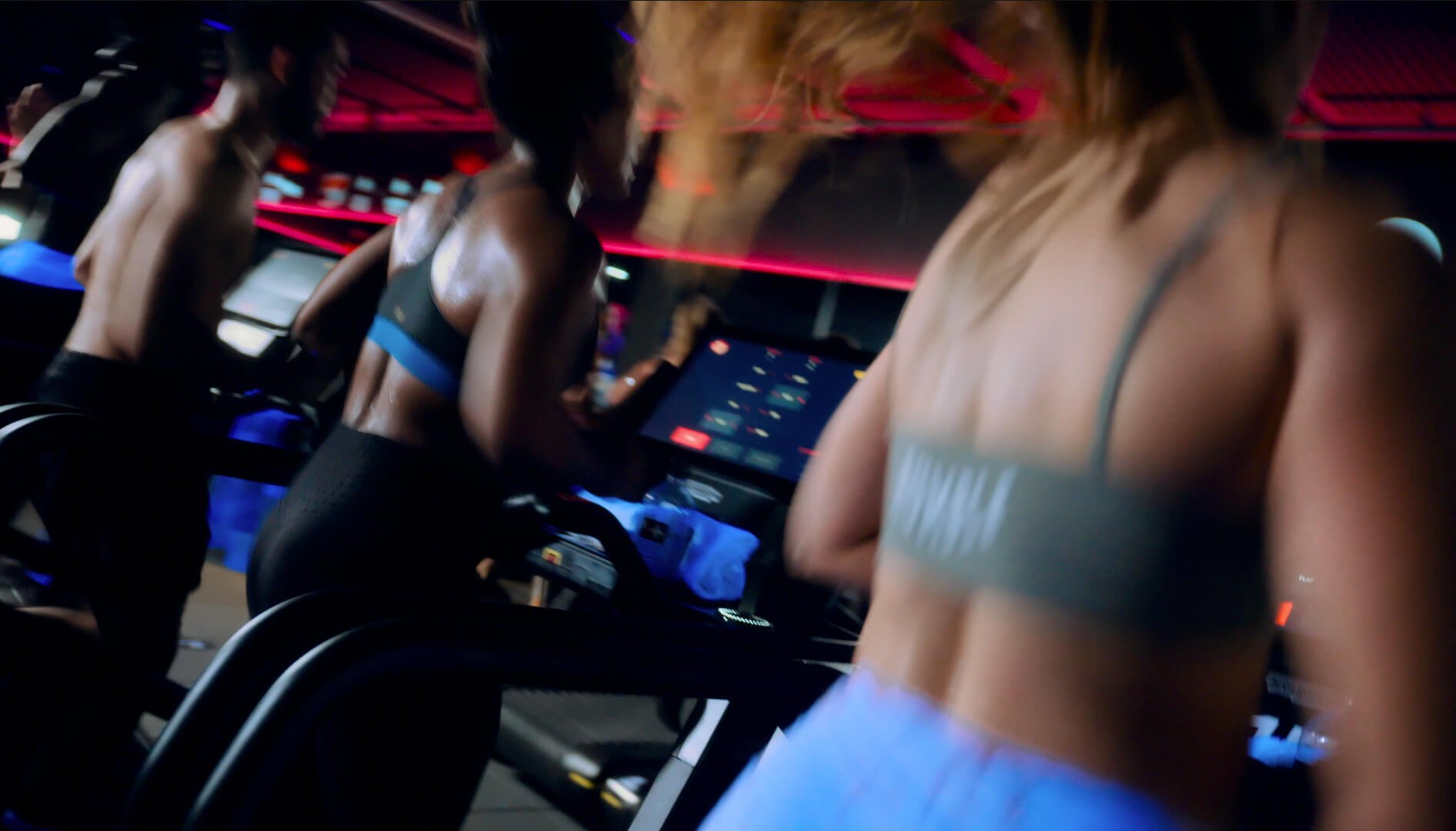 Group running on treadmills at Rumble